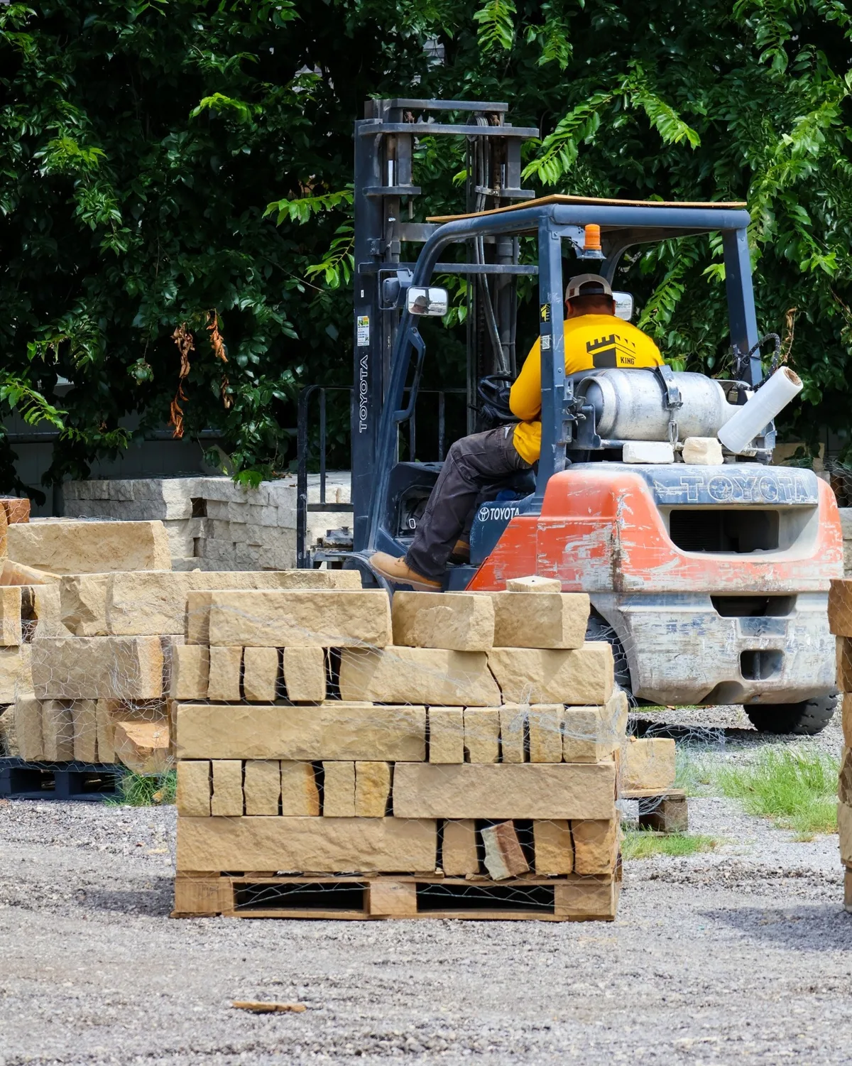 Forklift loading pallets of Lueders chop stone at the King Stone Supply yard