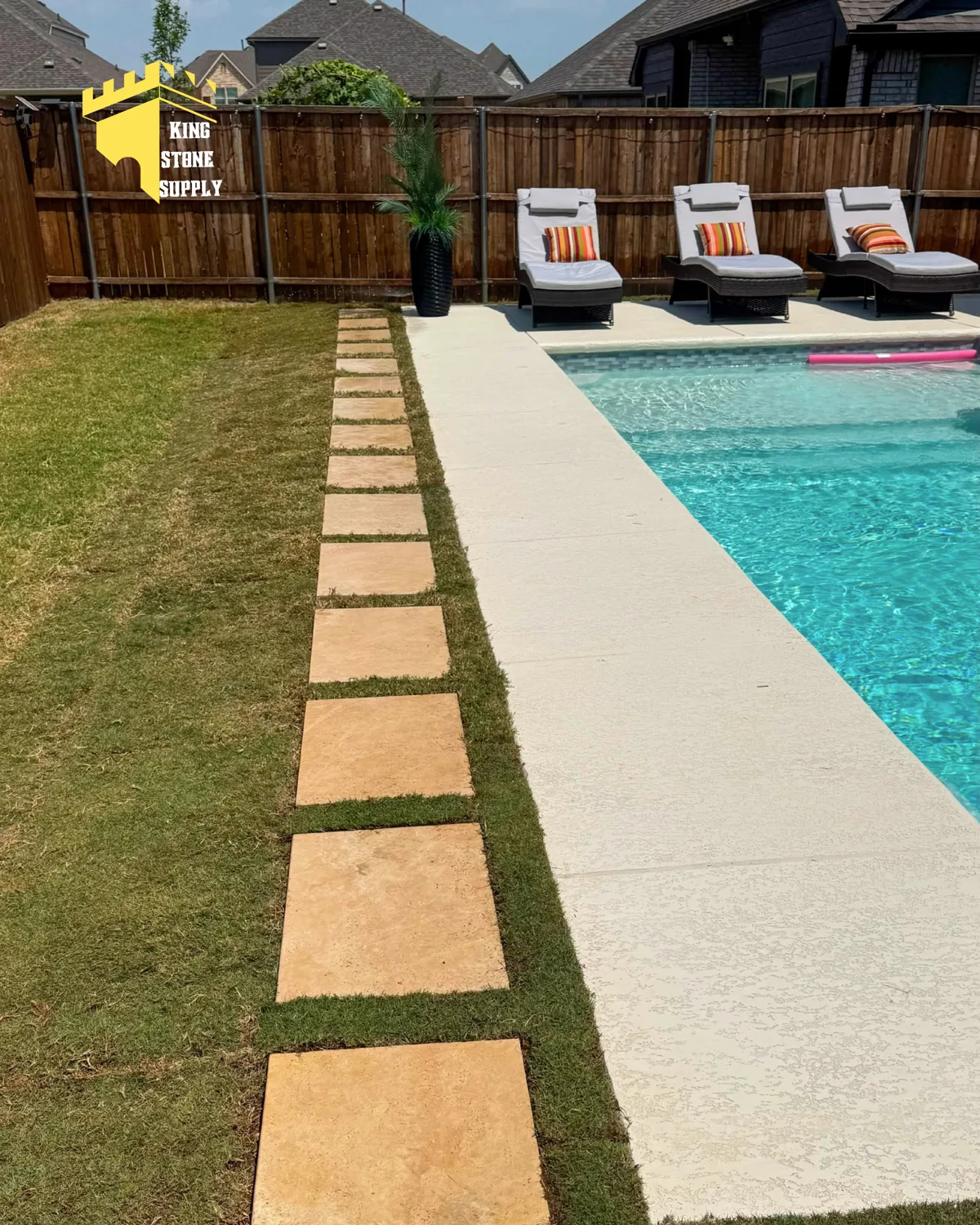 Natural stone stepping pavers beside a backyard pool
