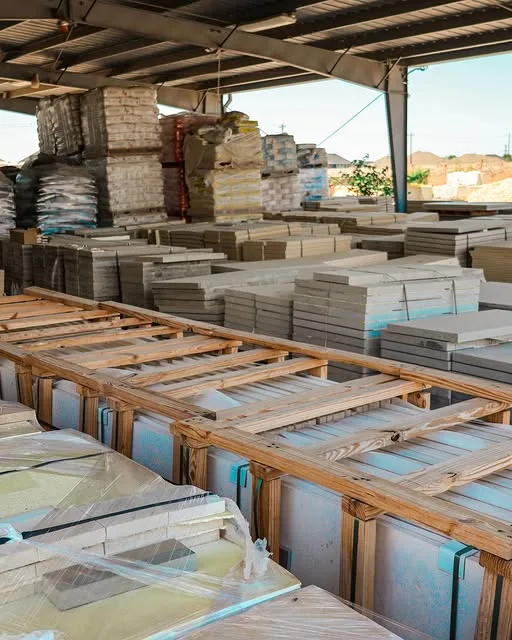Pallets of stone stacked under the canopy at the yard
